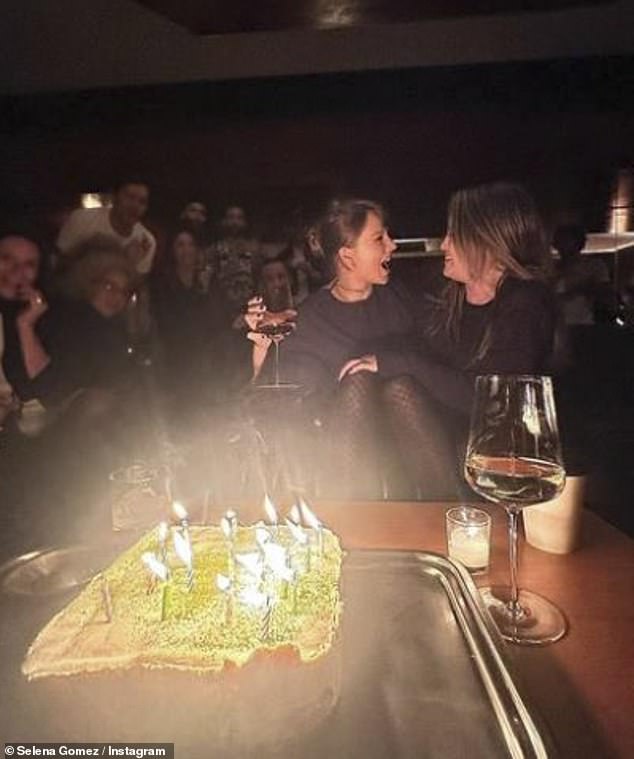 На другом снимке она праздновала день рождения с именинницей Тейлор и друзьями с большим праздничным тортом и зажженными свечами перед ними.