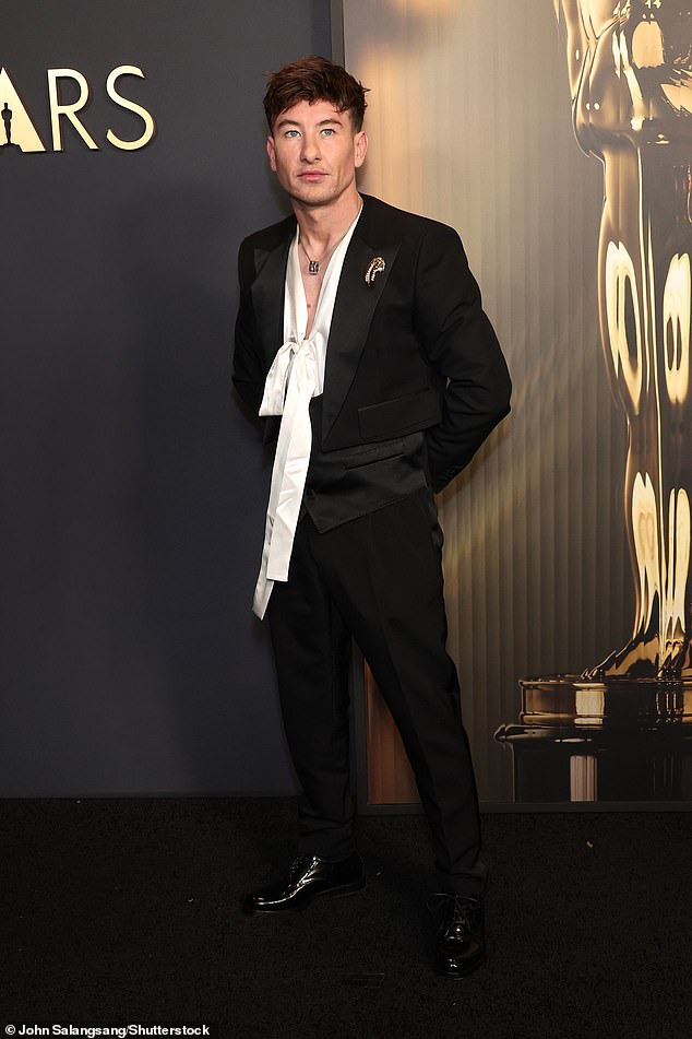 Тем временем 32-летний ирландский актер Барри Кеоган продемонстрировал свой уникальный стиль, надев белую рубашку с оборчатым воротником под черный смокинг.